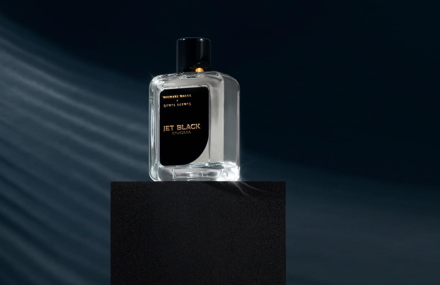 Michael Malul Jet Black Enigma being spritzed for a refined moment.