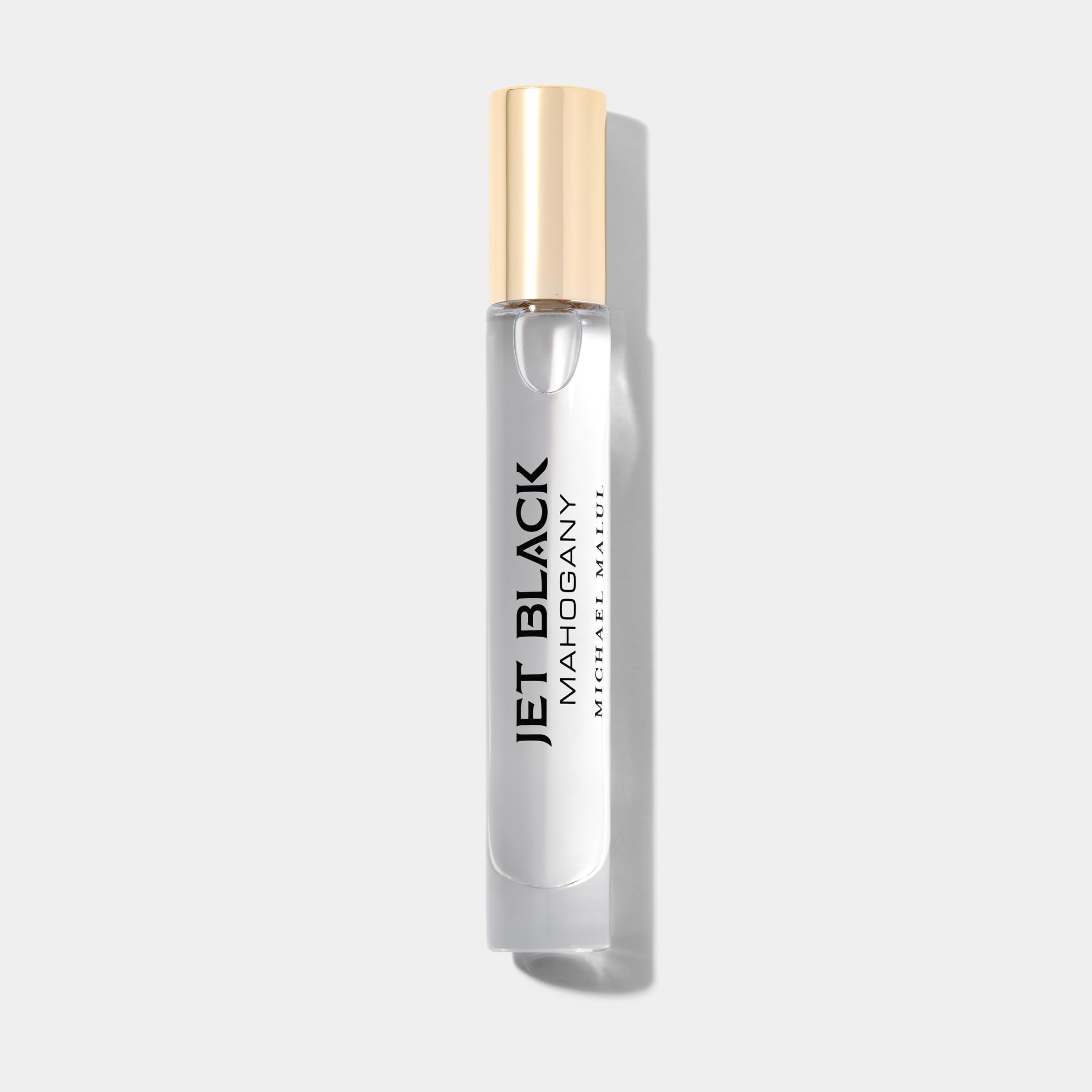 Michael Malul Jet Black Mahogany cap and bottle highlighting premium, travel-ready scent.