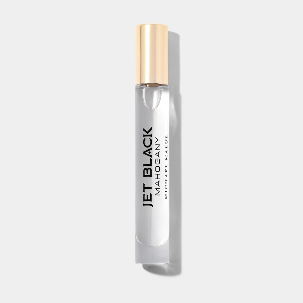 Michael Malul Jet Black Mahogany cap and bottle highlighting premium, travel-ready scent.