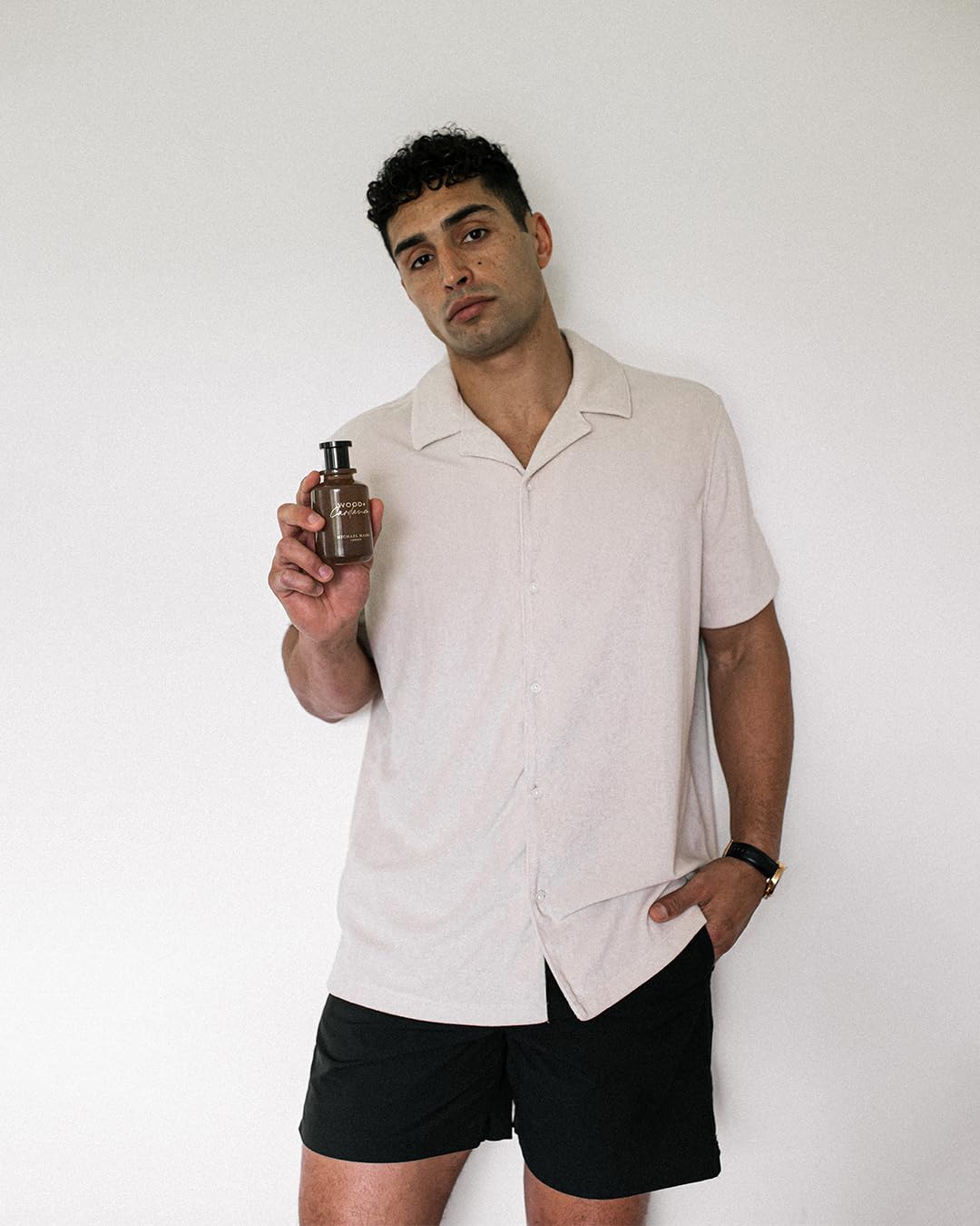 Wooden surface shot with Michael Malul Wood + Cardamom EDP.