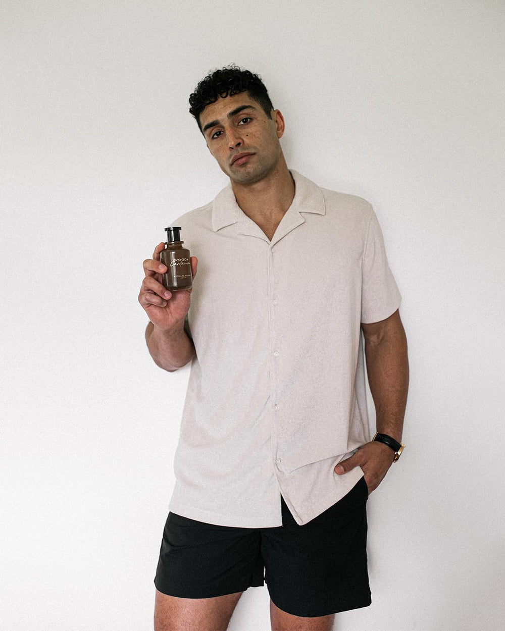 Wooden surface shot with Michael Malul Wood + Cardamom EDP.