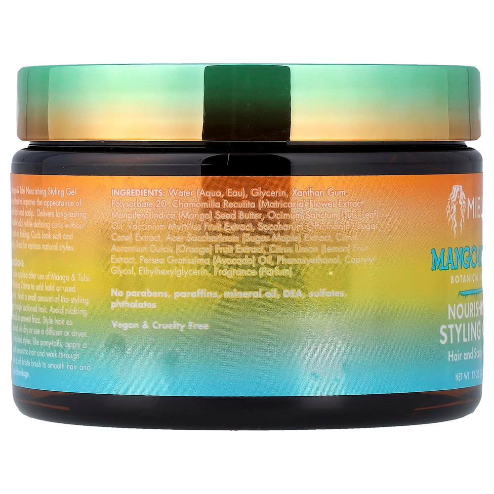 Hands applying Mielle Mango Tulsi gel for defined curls.