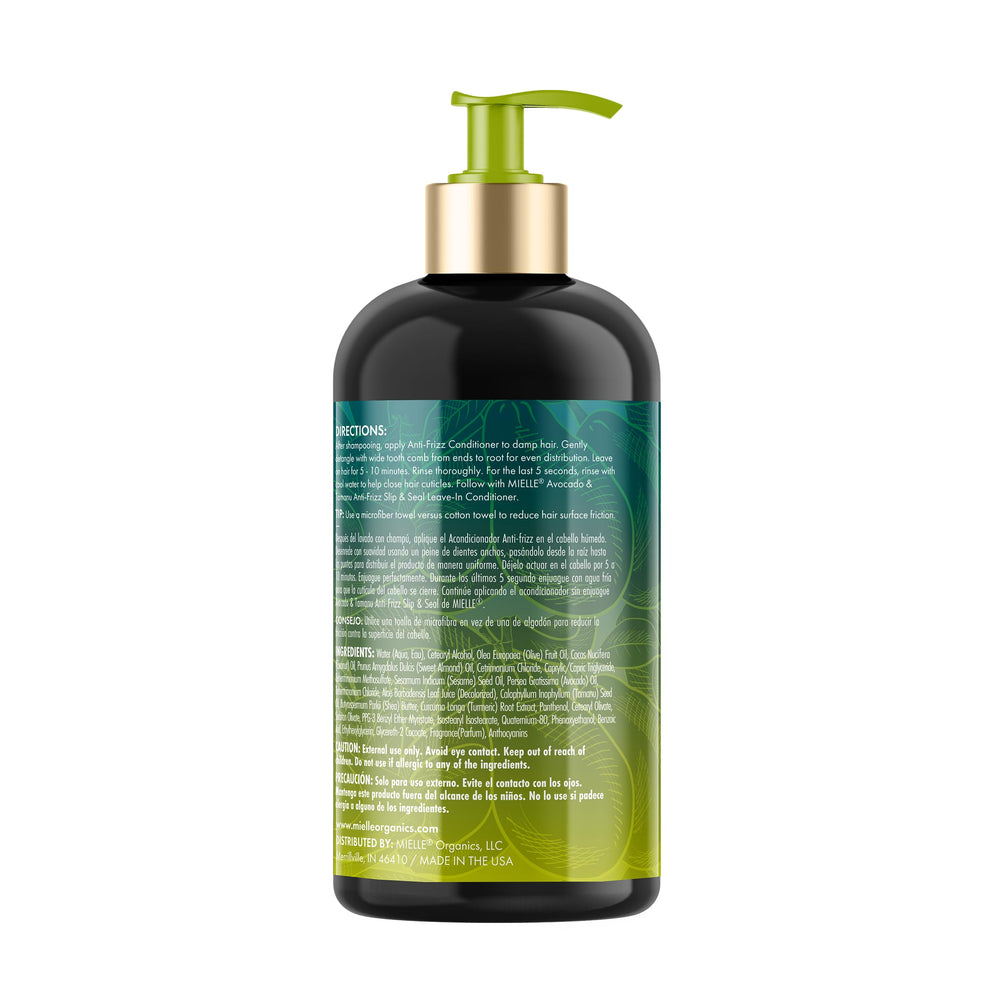 Wide-tooth comb detangling hair with Mielle Organics Avocado and Tamanu Conditioner.