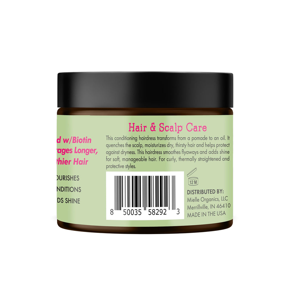 Mielle Organics Rosemary & Mint pomade during application conveys scalp care in action.
