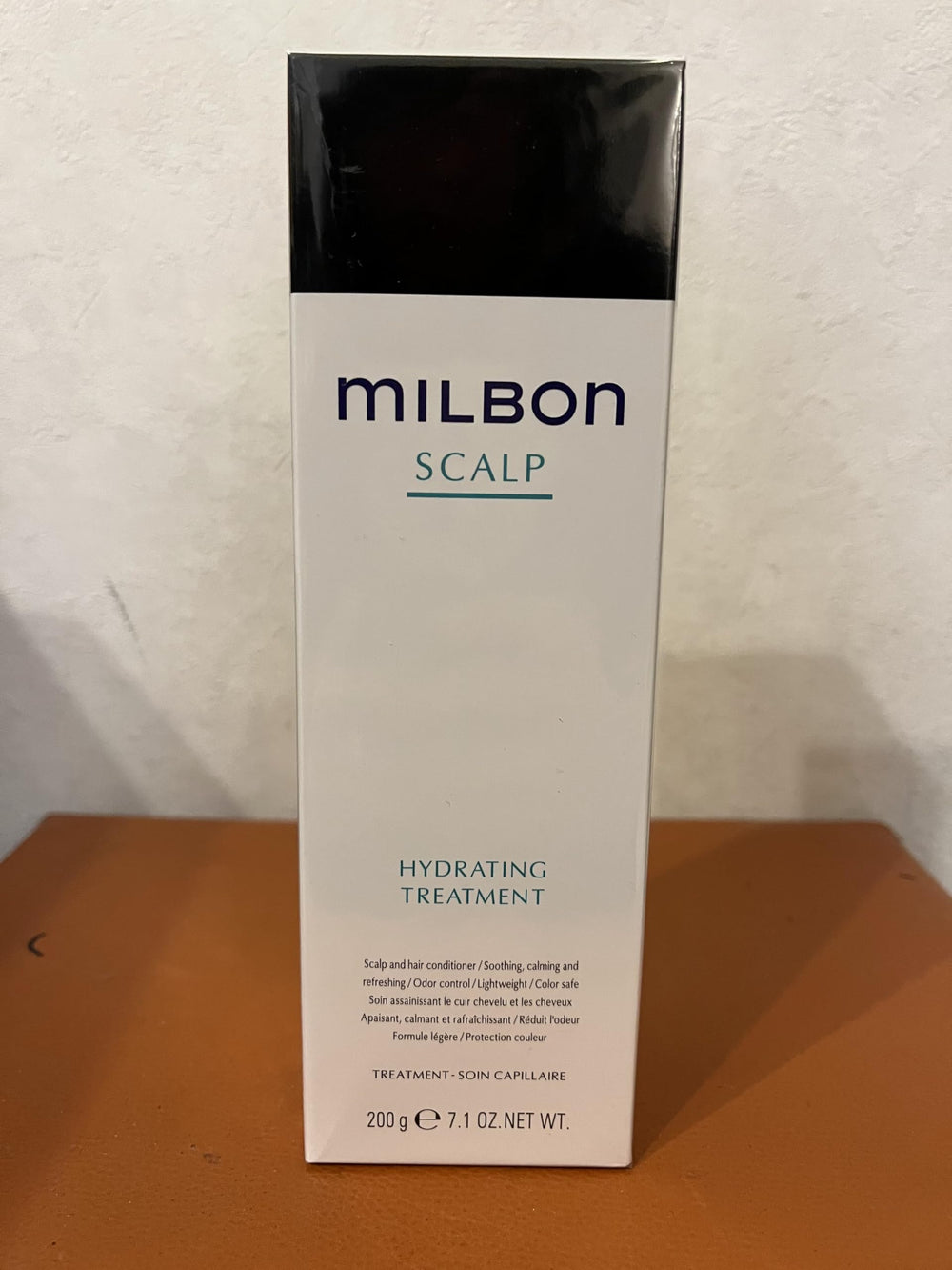Milbon Scalp Hydrating Treatment bottle close-up, highlighting hydration for scalp comfort.