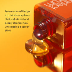 Mise En Scene Perfect Serum Original Shampoo argan oil closeup, highlighting deep nourishment for curls