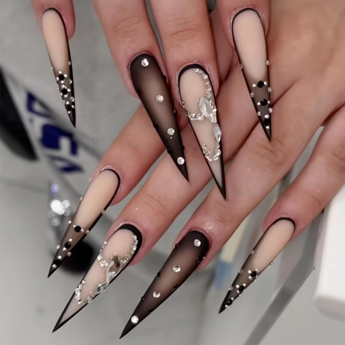 MISUD long stiletto nails with goth ombre and rhinestones for a bold evening look.