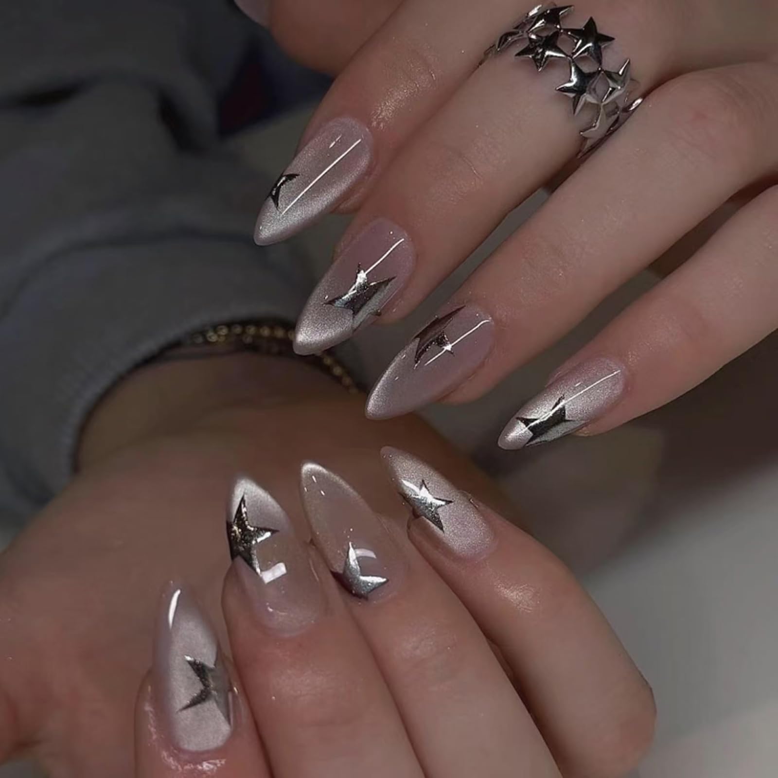 Mivota almond cat eye nude nails featuring 3D stars for a chic party-ready look.