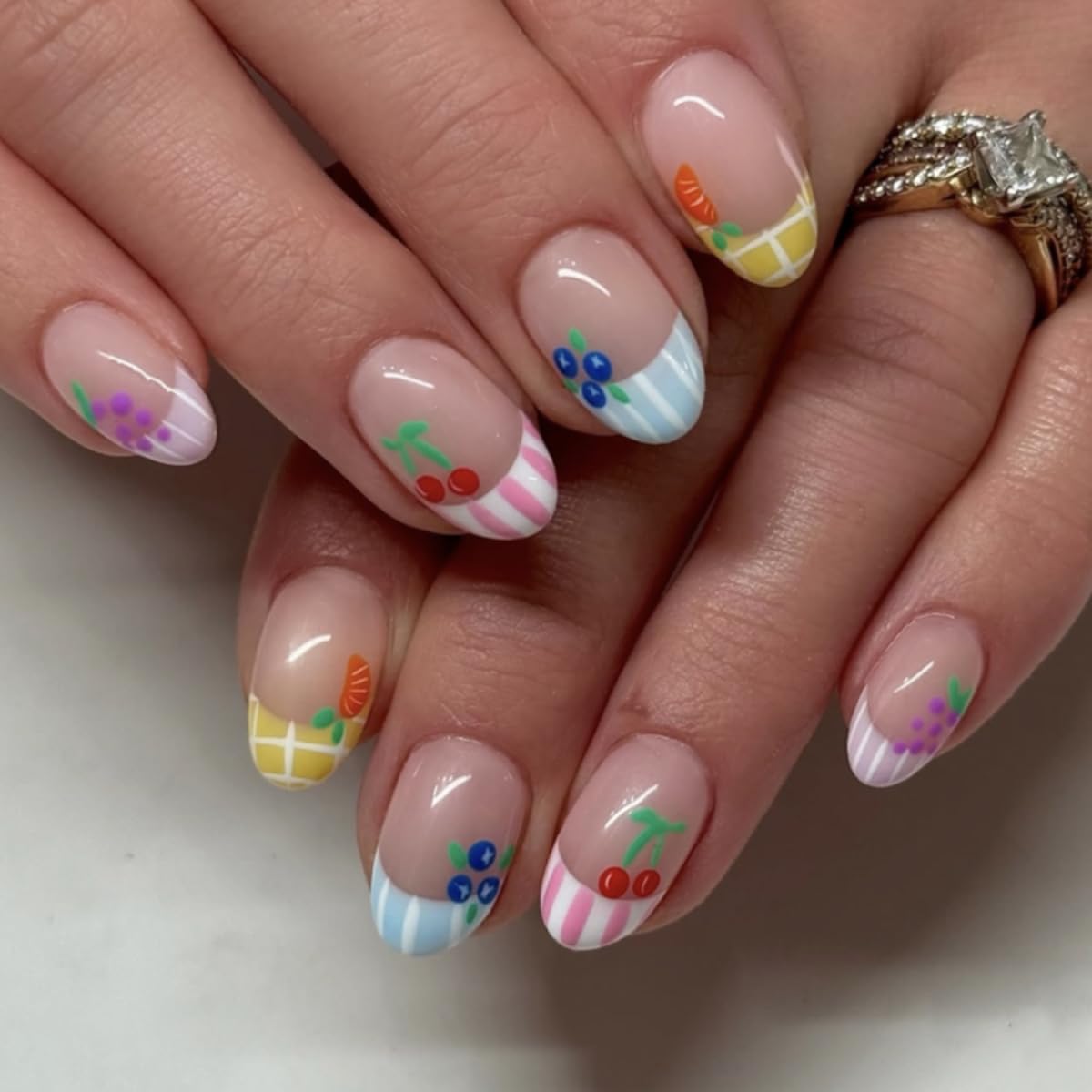 Mivota fruit press-on nails with nude short oval shape and pastel stripes for everyday chic