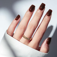 Modelones brown press-on nails in a short square tray for quick manicure.