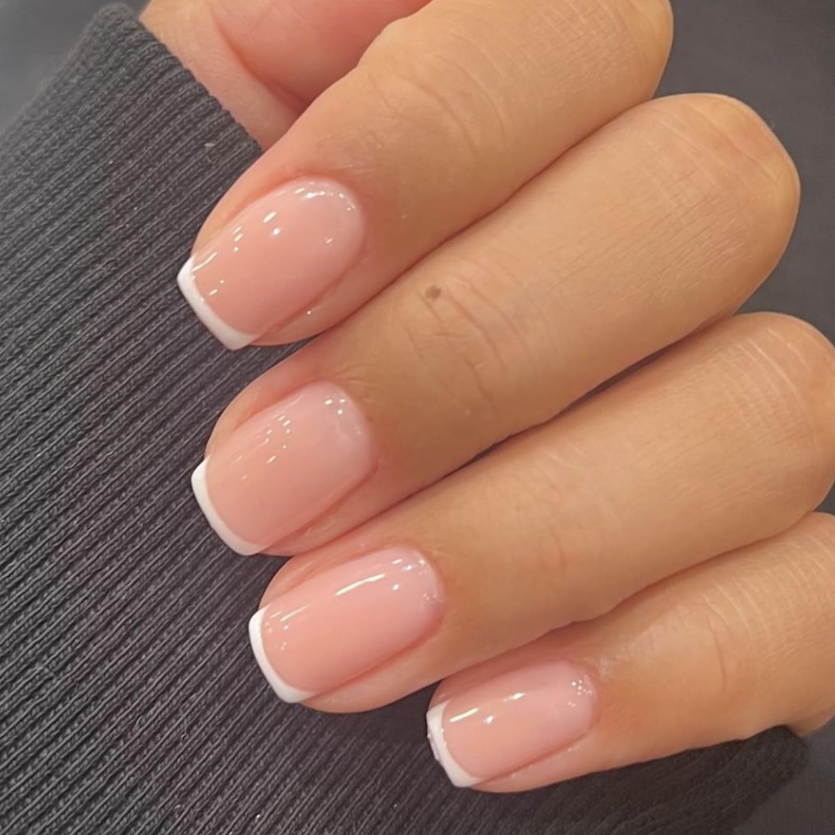 Modelones extra short press on nails in white packaging showing ready-to-wear elegance.