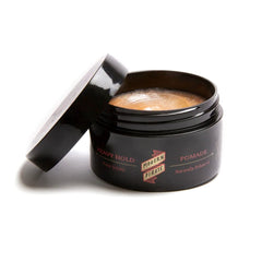 Modern Pirate Heavy Hold Pomade jar close-up highlighting re-activatable, water-based formula.