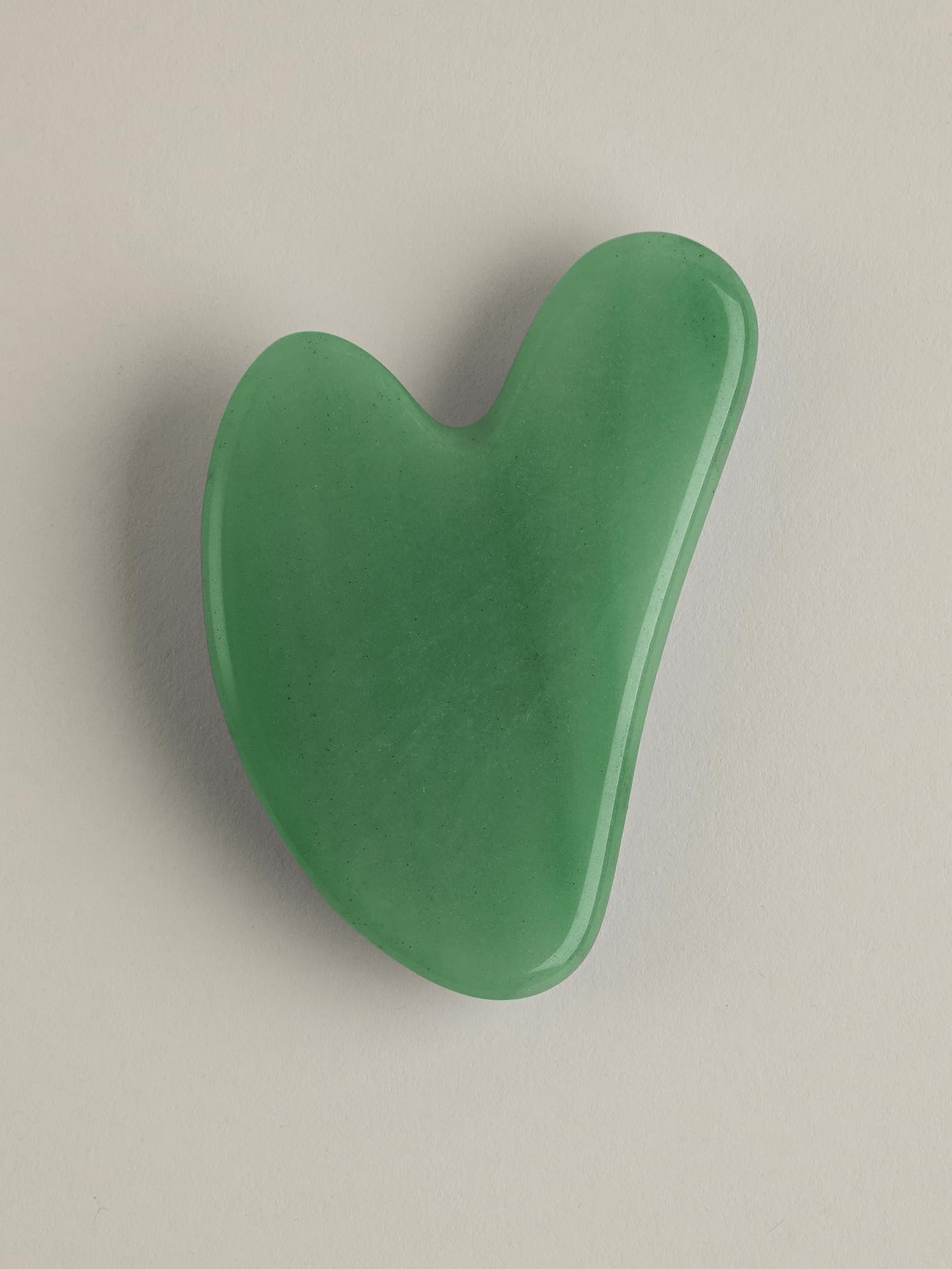 Mount Lai gua sha usage guide beside skincare products.