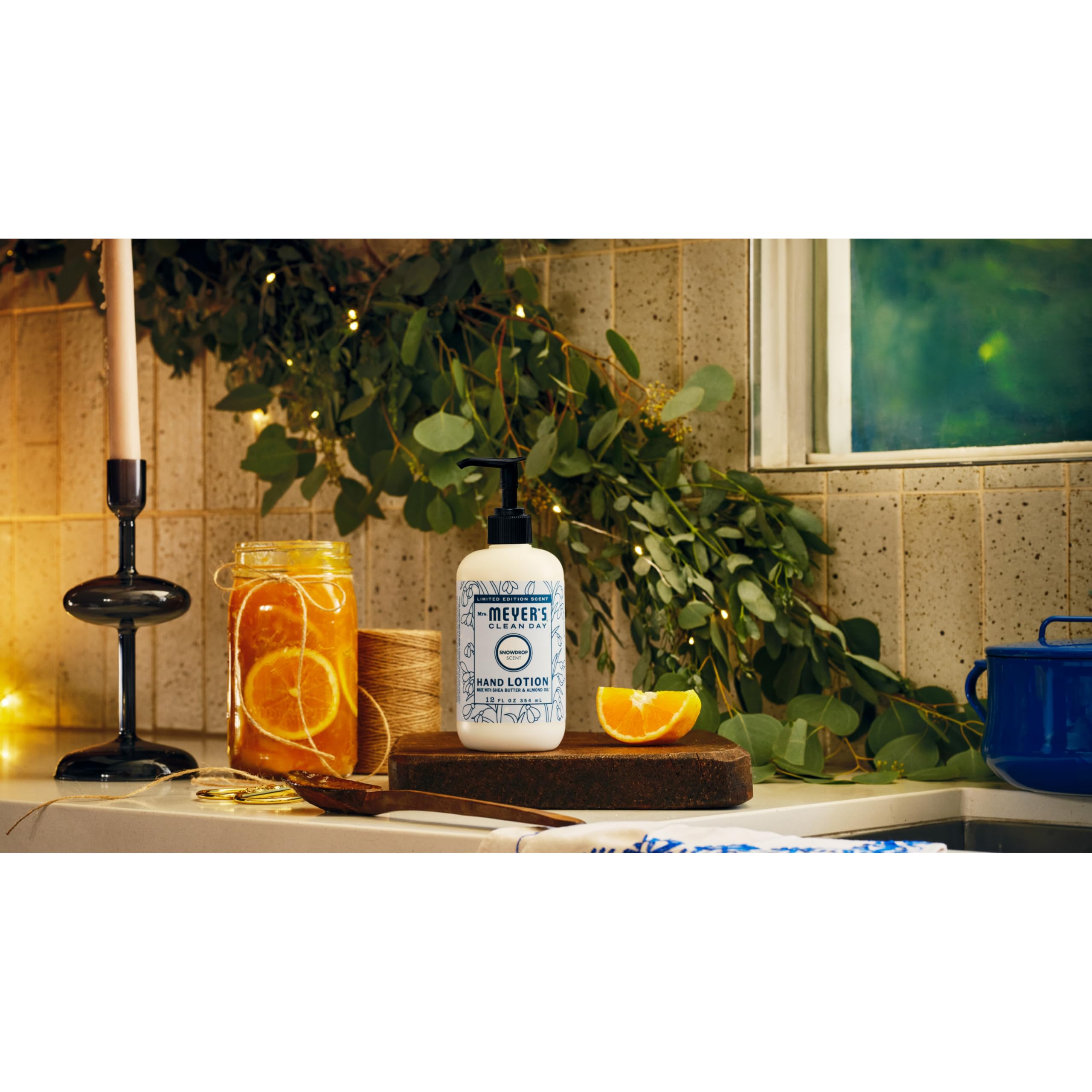 Flat lay of Snowdrop lotion with winter decor.