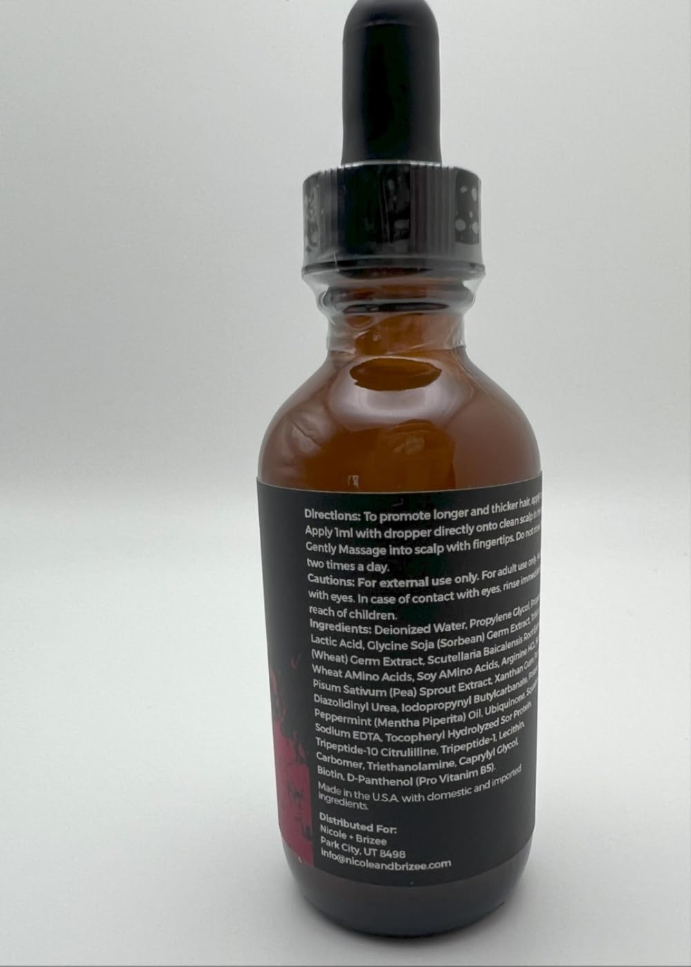 Product scene with N+B Hair Serum on bathroom shelf.
