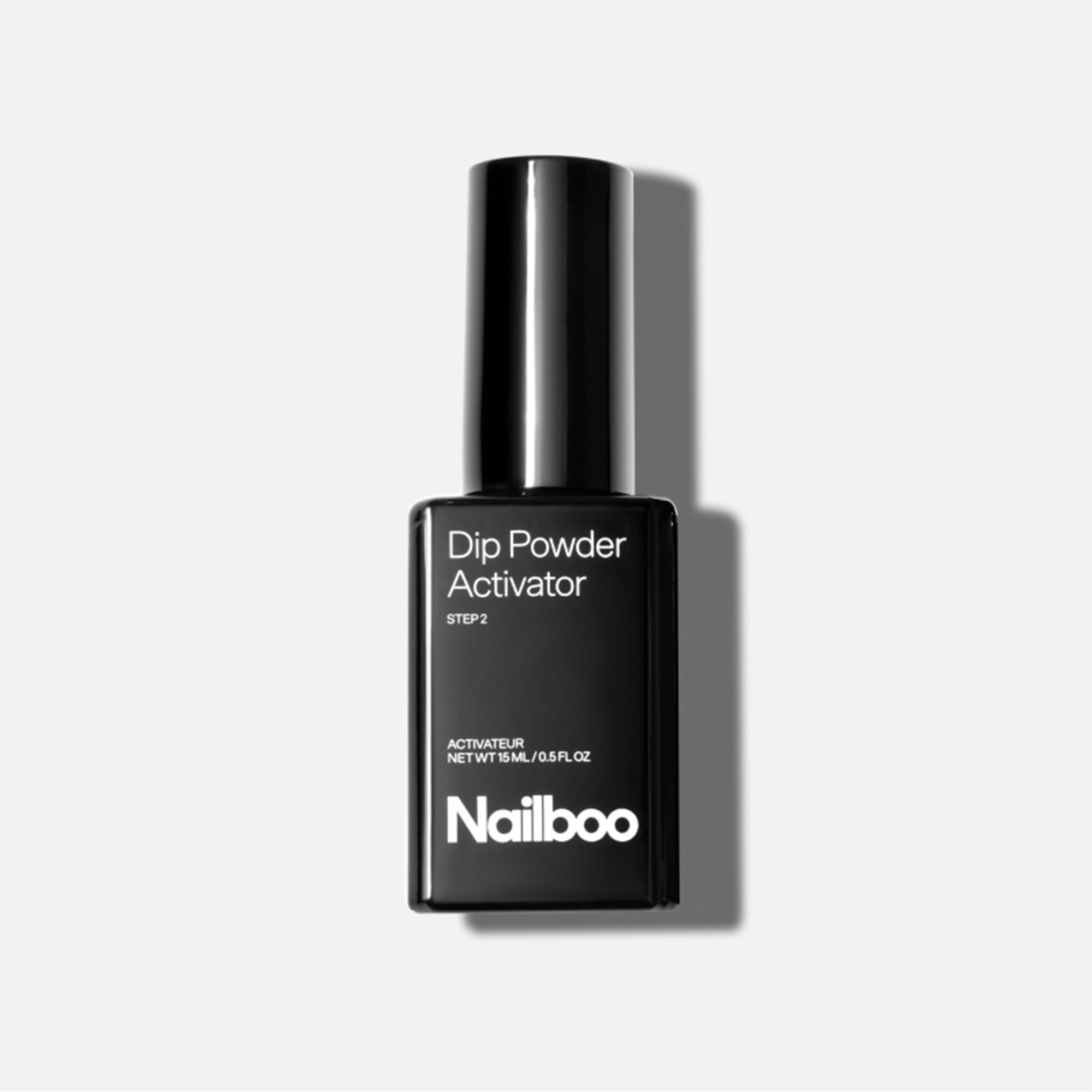 Nailboo Activator bottle closeup for quick, long-lasting dip manicures.