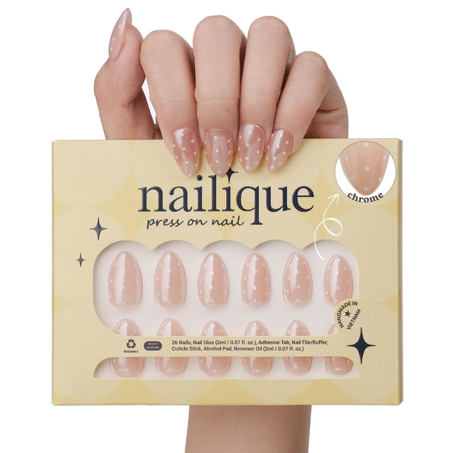 Nailique glazed donut nails in almond chrome nude with white polka dots for wedding-ready style.
