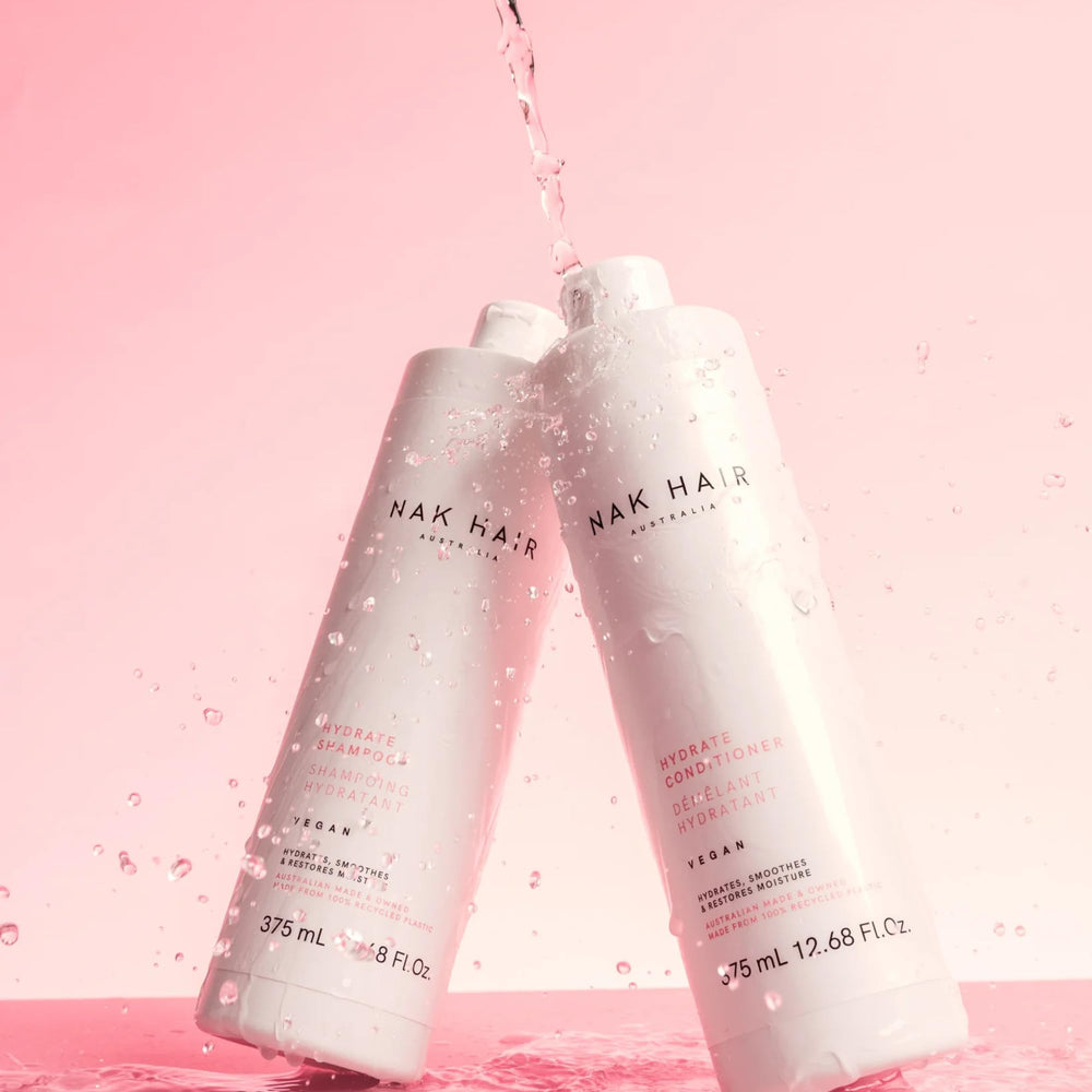 A rich lather from NAK Hair Hydrate Shampoo in hand, cleansing dehydrated hair gently.