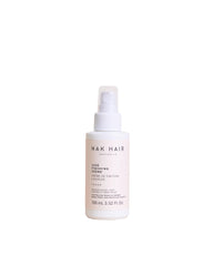 NAK Hair Luxe Finishing Creme bottle on vanity for light shaping and frizz control