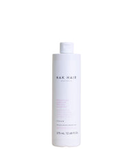 NAK Hair Structure Complex Shampoo bottle highlighting strength and hydration for damaged hair.