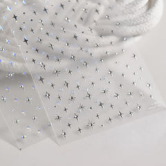 Aurora silver star decals decorate natural or artificial nails.