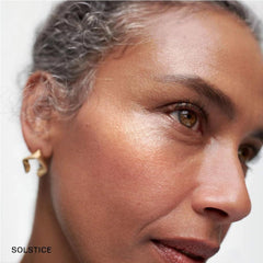 NAPH M Day Glow Balm swirled on cheek for a natural dewy highlight.