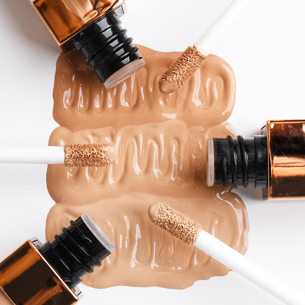 NATASHA MOOR concealer bottle emphasizes Vitamin E for nourished skin.