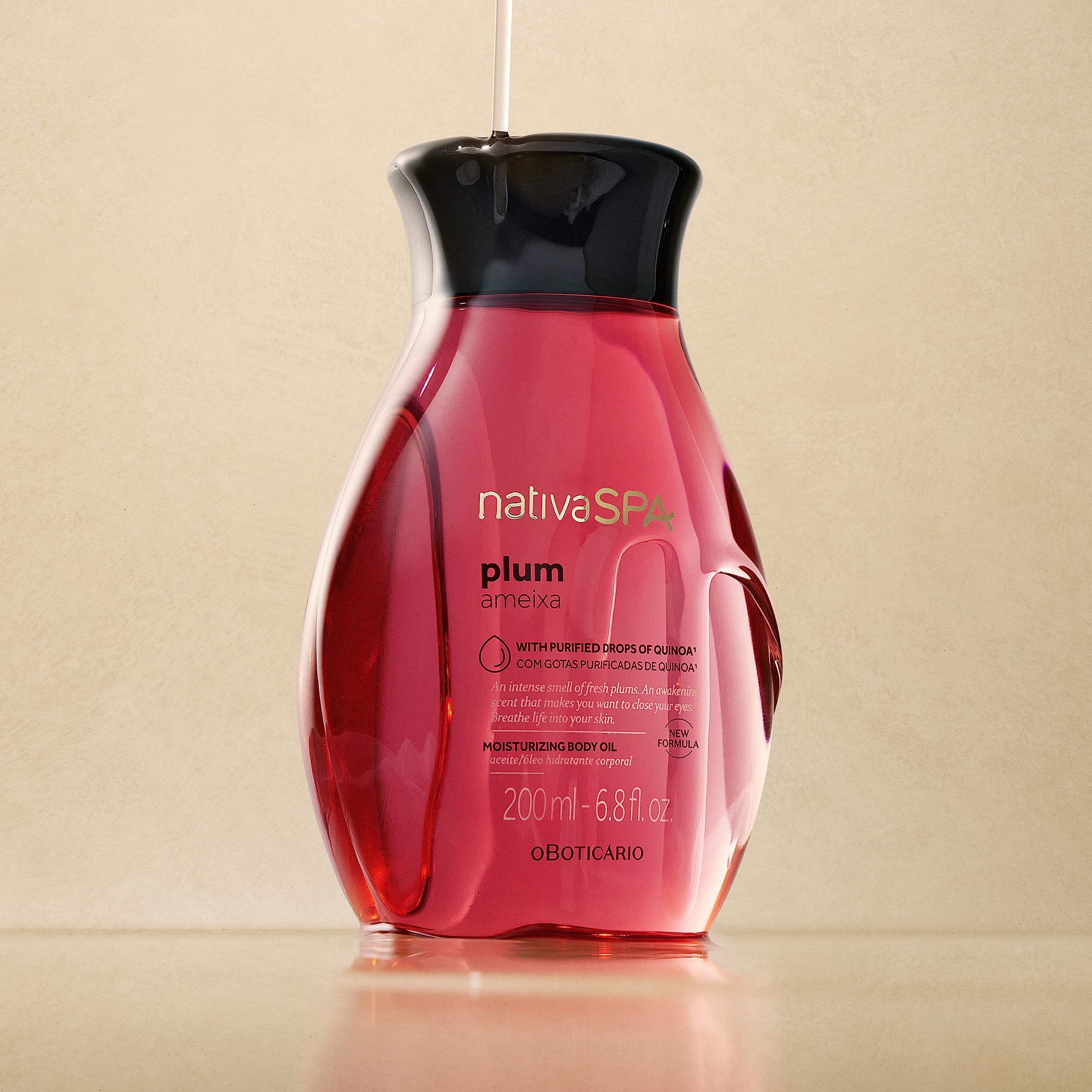 NATIVA SPA Plum Body Oil being poured to show quick absorption.