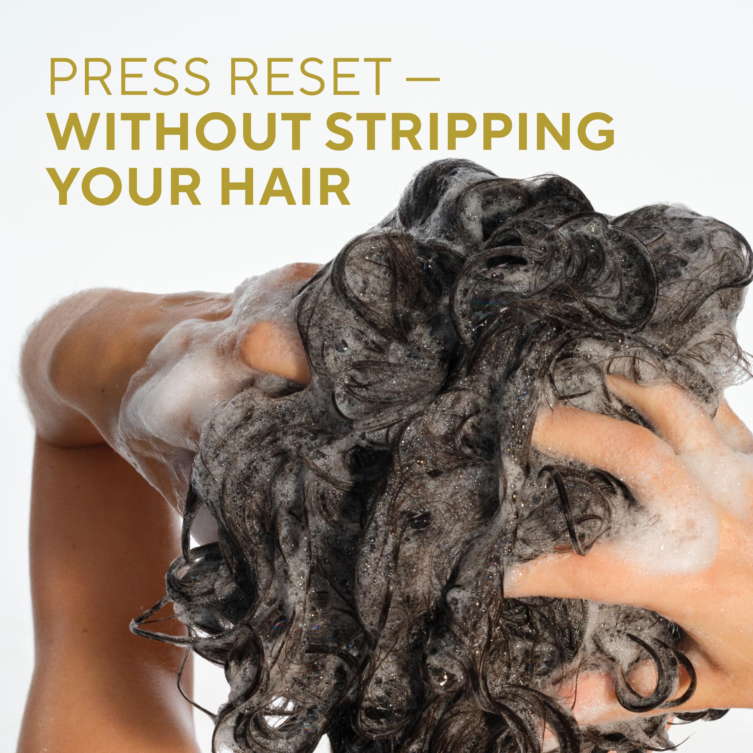 Conditioner being rinsed, smoothing strands without weighing down curls