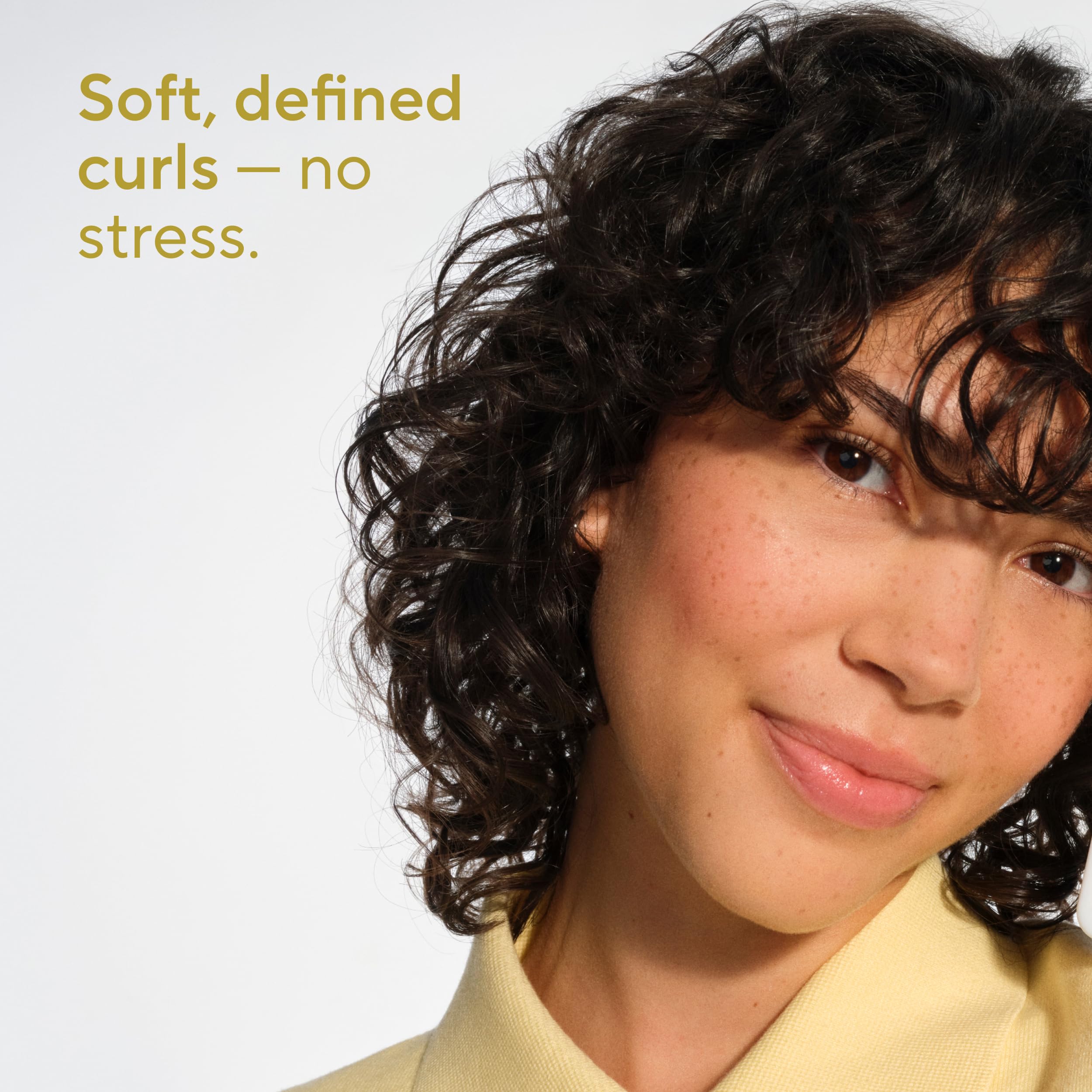 Close-up of shampoo lather showing weightless curls and defined waves with Native