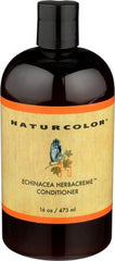 Naturcolor Echinacea Herb Creme Conditioner wrapped in towel for deeper conditioning.