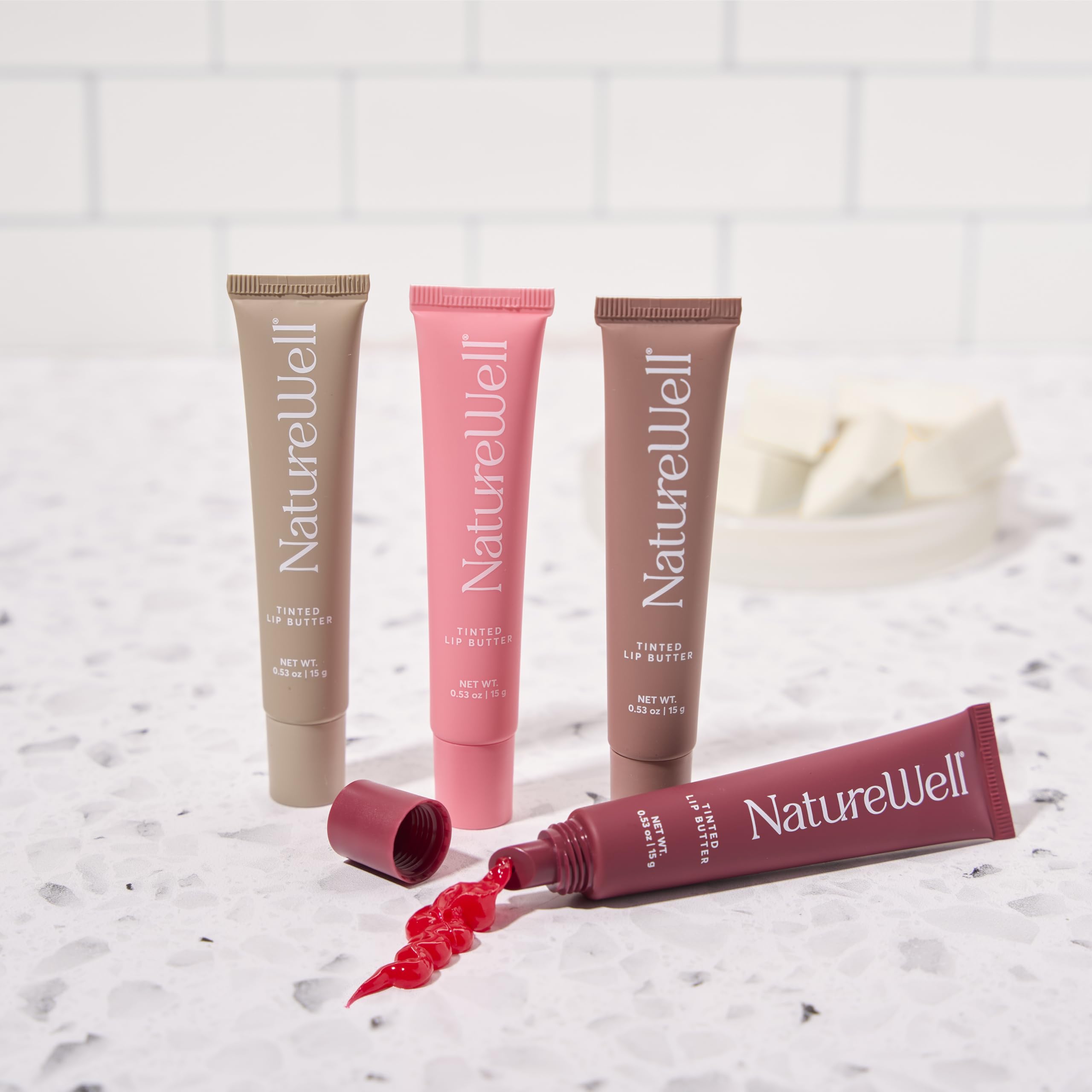 NATURE WELL Lightweight non-greasy lip butter on lips with sheen