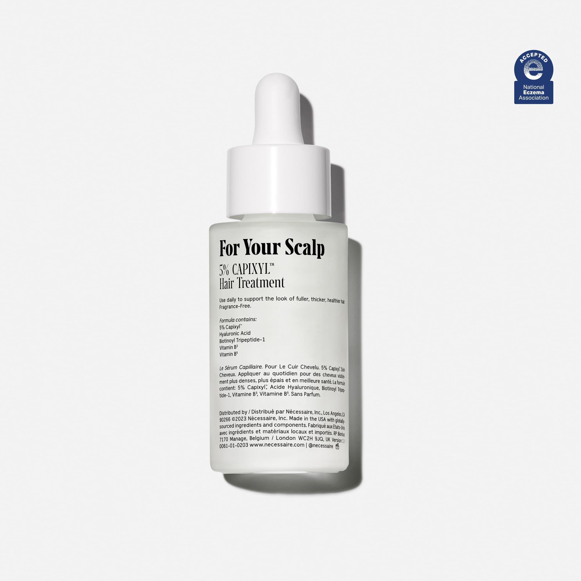 Nécessaire Scalp Serum glass bottle close-up showing minimalist fragrance-free design.