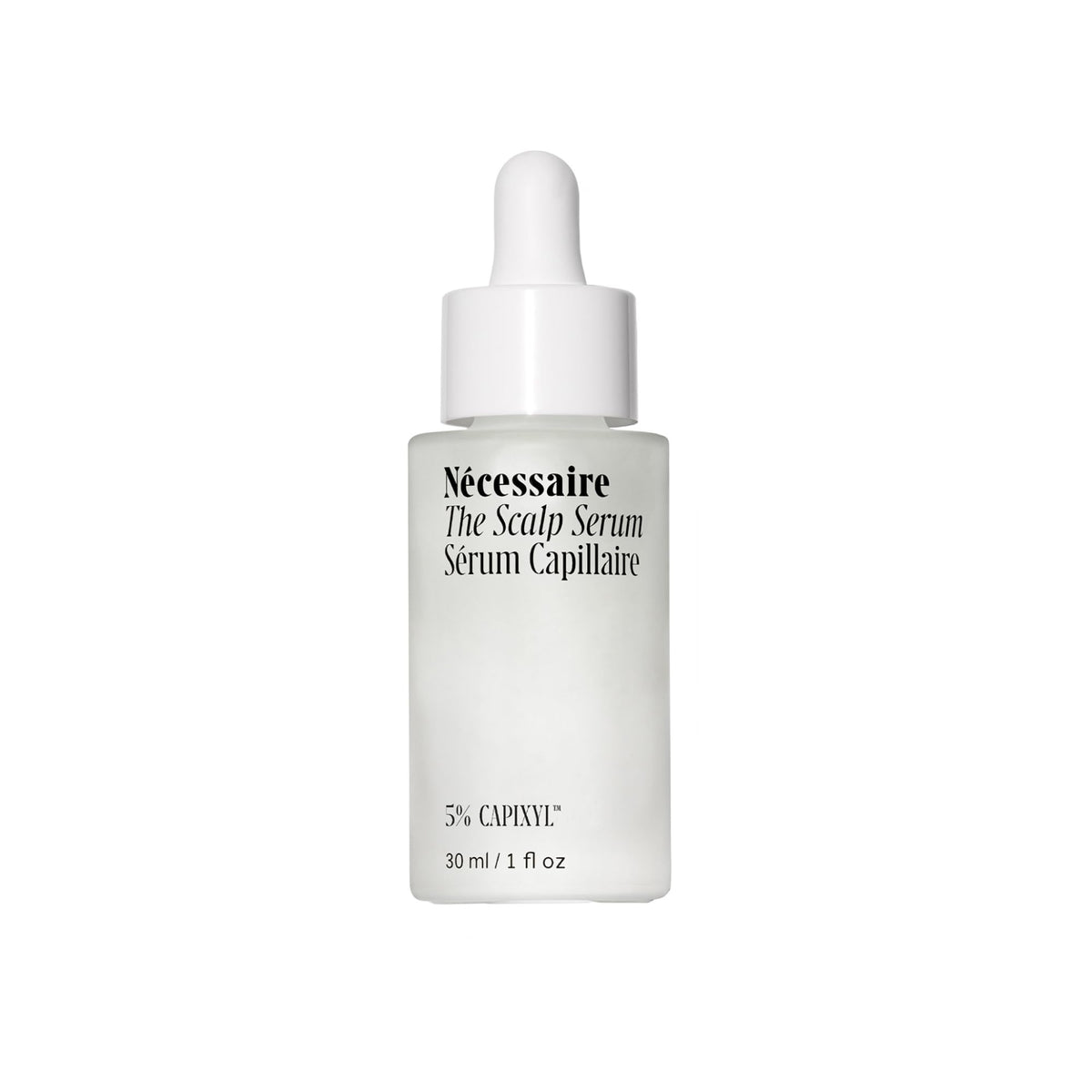 Nécessaire Scalp Serum pipette dispensing on a glass bottle for precise application on the scalp.