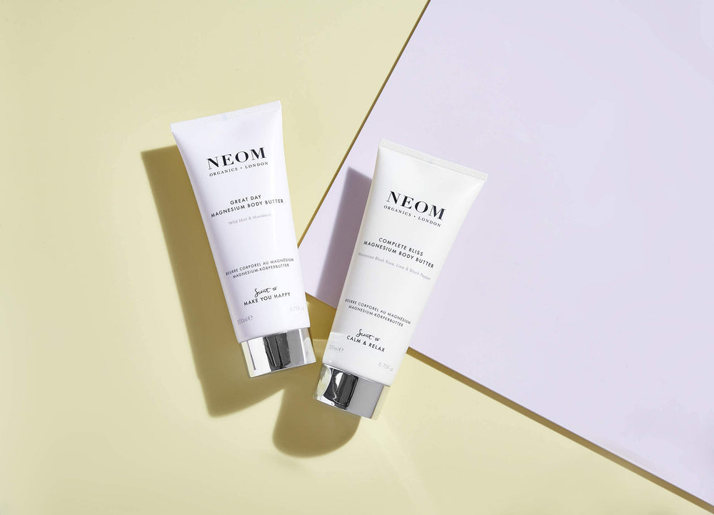 Neom Great Day butter being massaged into skin demonstrates ritual use.