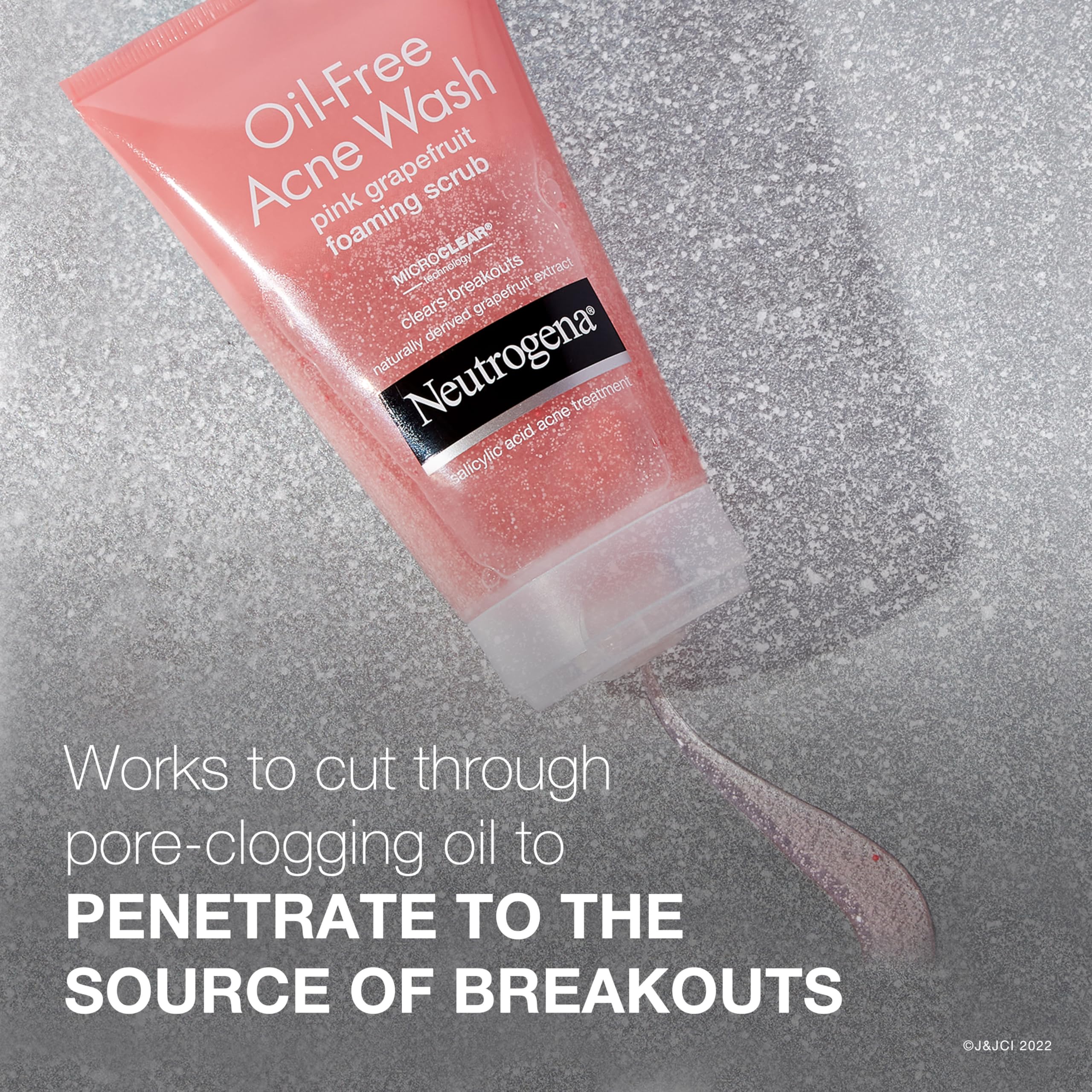 Three-pack display of Neutrogena Oil-Free Pink Grapefruit Foaming Scrub on shelf.