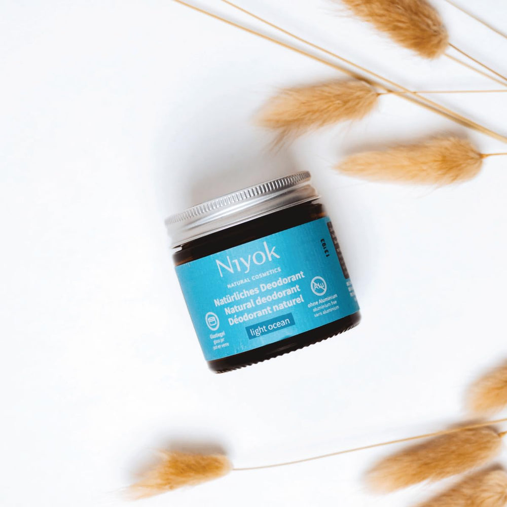 Niyok travel-friendly brown glass jar fits on-the-go routines.