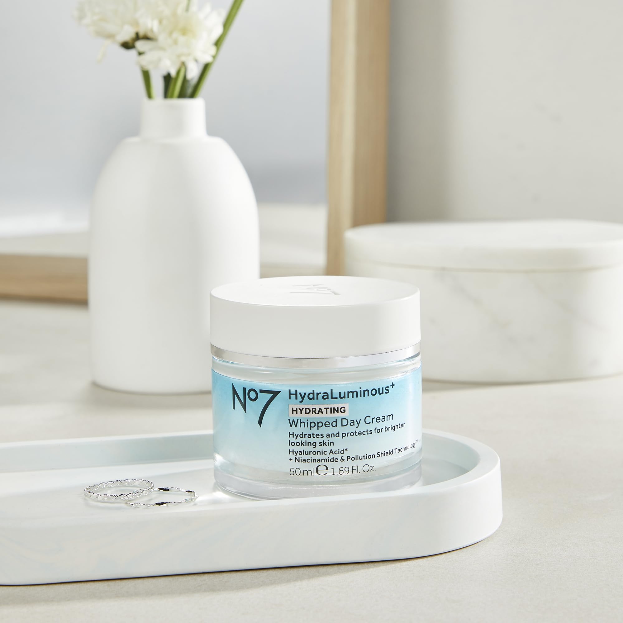 A person applying No7 HydraLuminous+ to face for morning hydration.