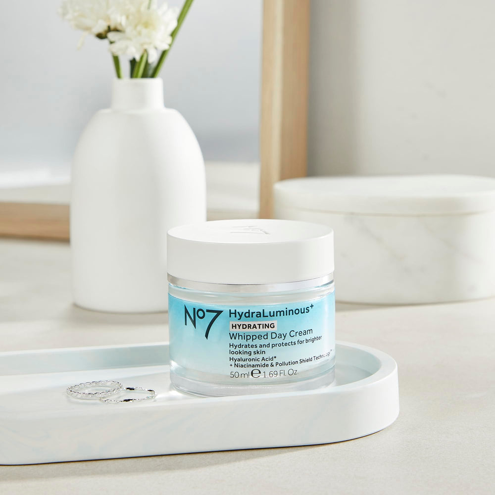 A person applying No7 HydraLuminous+ to face for morning hydration.
