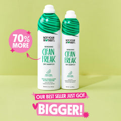Not Your Mother's Clean Freak bottle nozzle releasing spray for oil absorption.