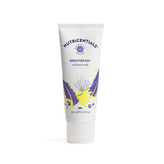 Nu Skin Brighter Day Exfoliant Scrub with pomegranate enzymes on a spa surface for a gentle glow.