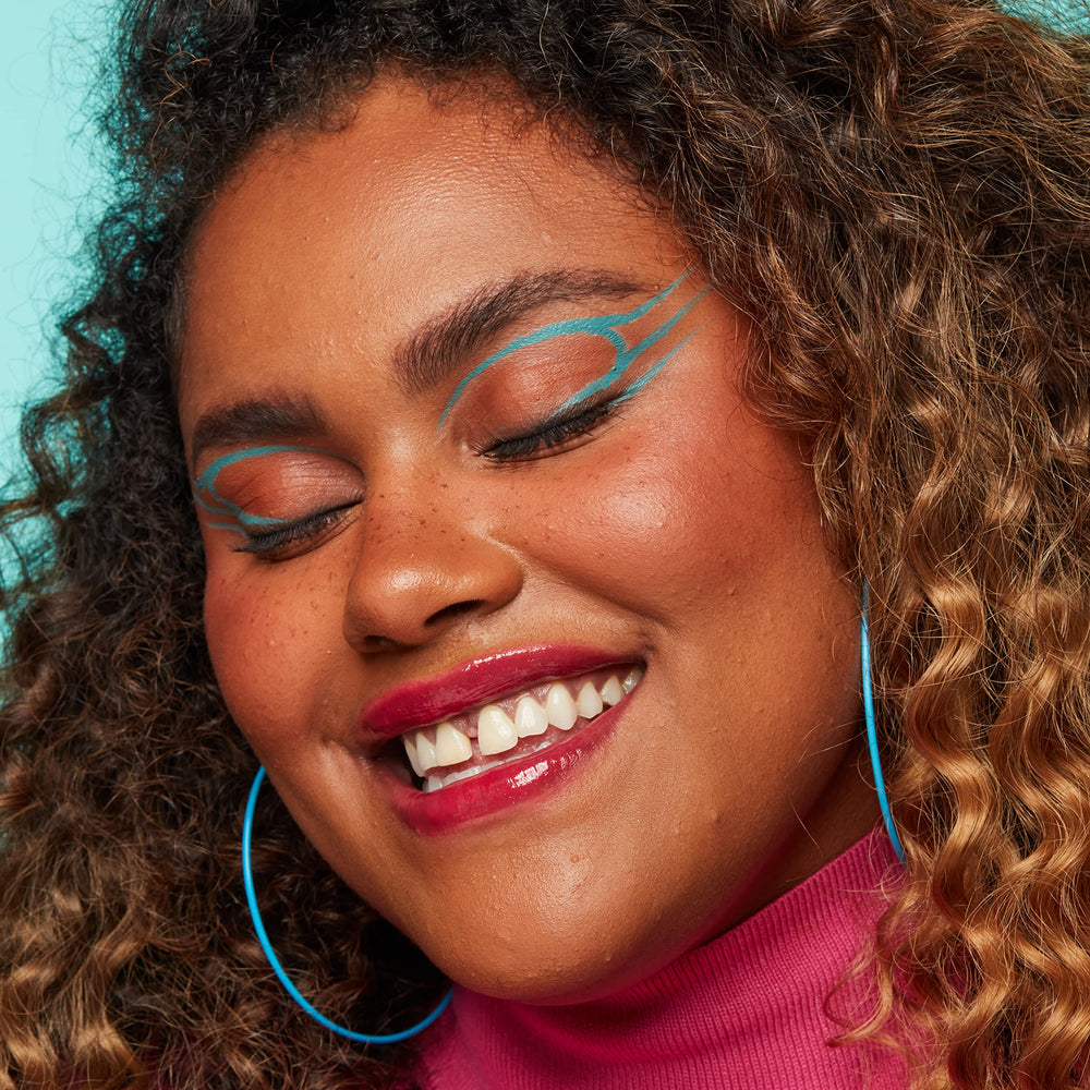 NYX Vivid Brights Cyan Simp skin swatch reveals vivid pigment for quick checks.