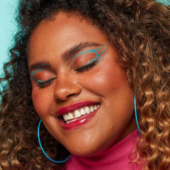 NYX Vivid Brights Cyan Simp skin swatch reveals vivid pigment for quick checks.