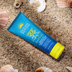 Athlete applying Ocean Potion Sport Sunscreen Lotion during hike.