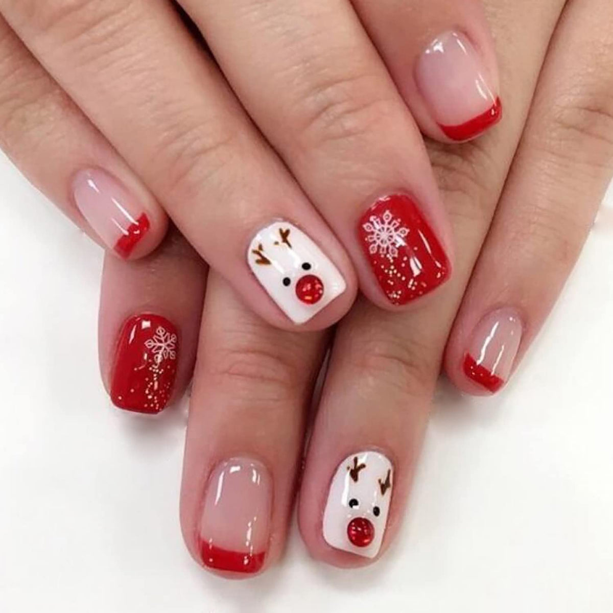 OCOUYVD Christmas nails with red tip and snowflake closeup for festive wear.