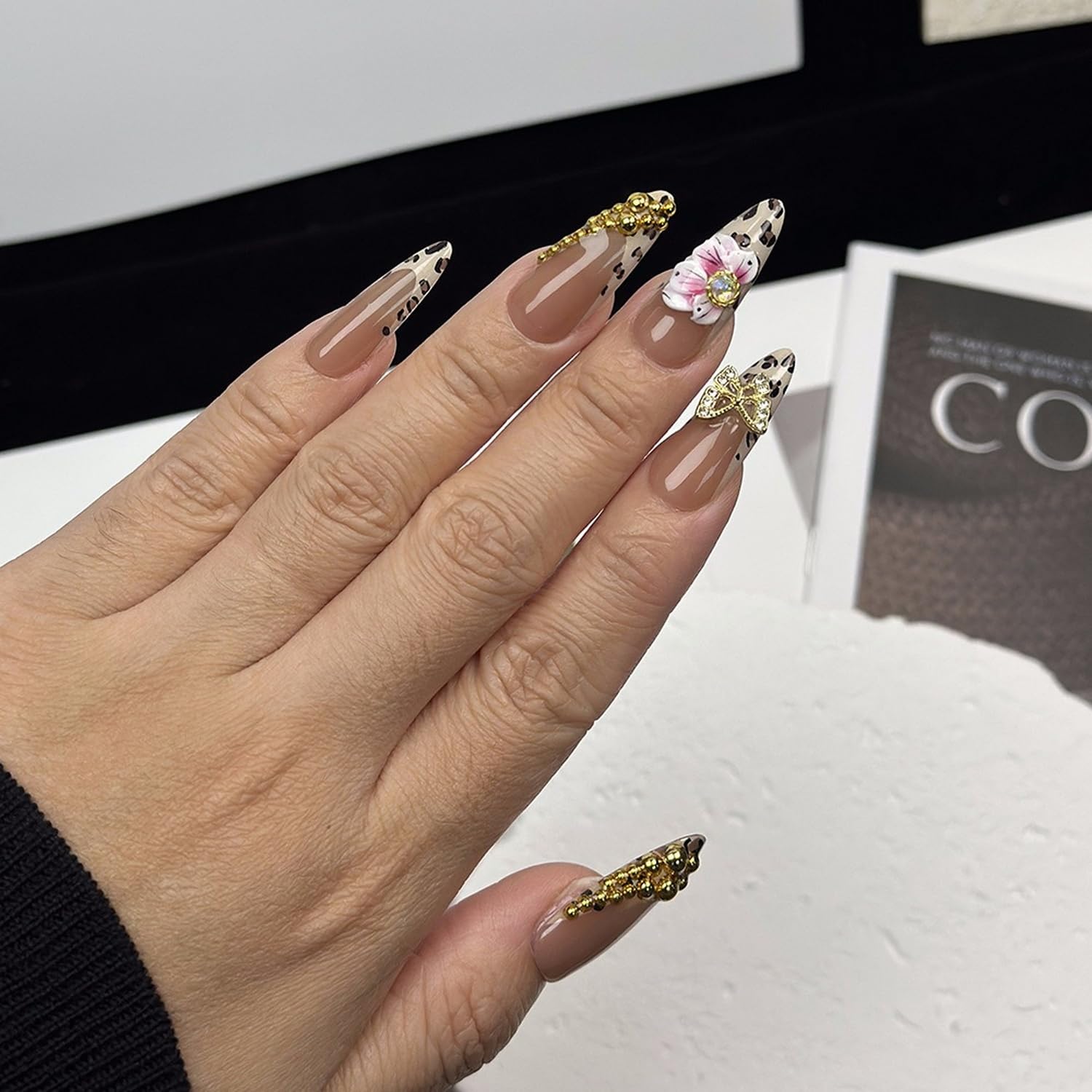 OCOUYVD Close-up of 3D rhinestones detail on leopard nails