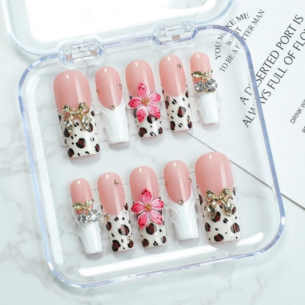 OCOUYVD White French Tip nails with bow embossing close-up for chic elegance.