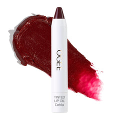Ogee Dahlia lip oil bottle shows burgundy tint with nourishing oils.