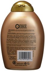 OGX shampoo bottle close-up highlighting keratin and cocoa butter for strength.
