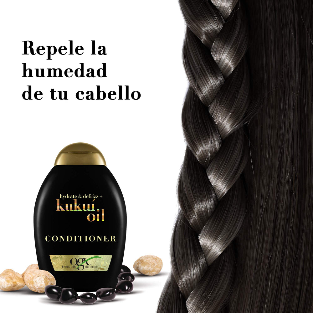 OGX Kukui Oil Conditioner hair strands with a smooth, shiny finish after use.